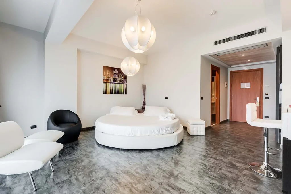 The image shows a large room with a round bed.